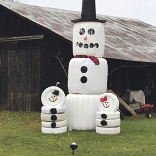 Photo submitted for publication Larry and Connie Upton's snowman, located on Mickle Hill near Garland, added snow children to the friendly neighborhood competition